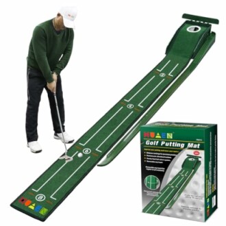 Person using an indoor golf putting mat with a boxed set nearby.