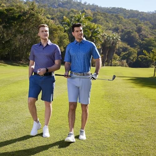 Two men walking on a golf course with clubs.